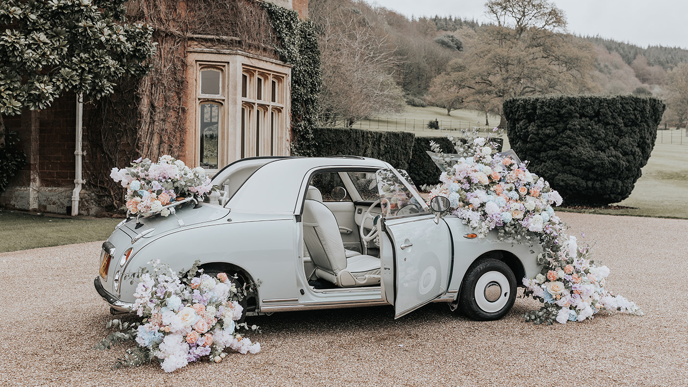 Classic Nissan Fidaro in Power Blue decorated with large bunch of flowers