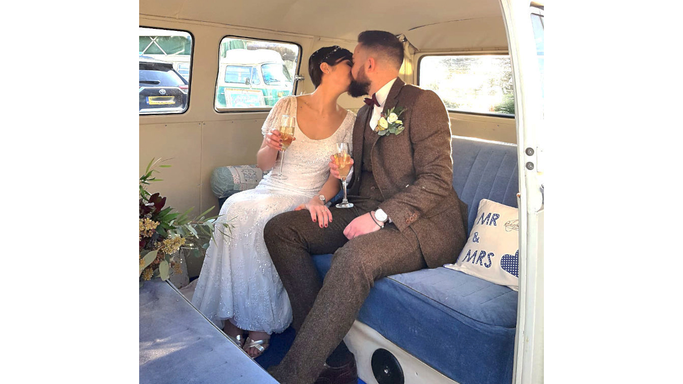 Blue interior inside VW Campervan with Bride and Groom Kissing