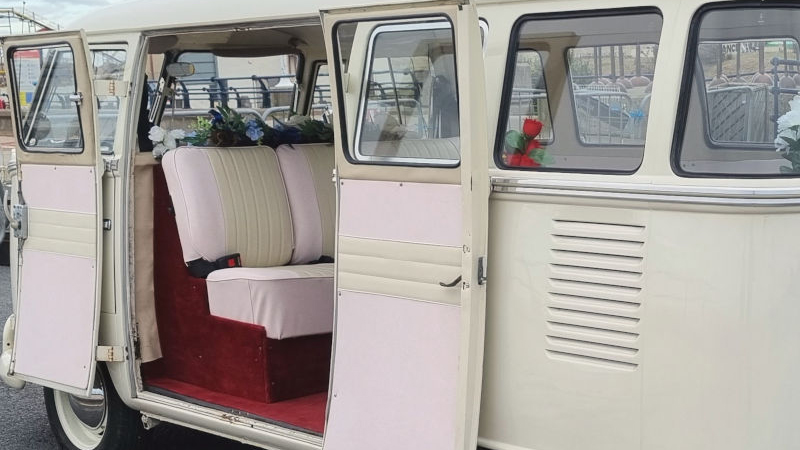 Rear passengers Double door open showing burgundy carpet and Cream and Pale Pink seats