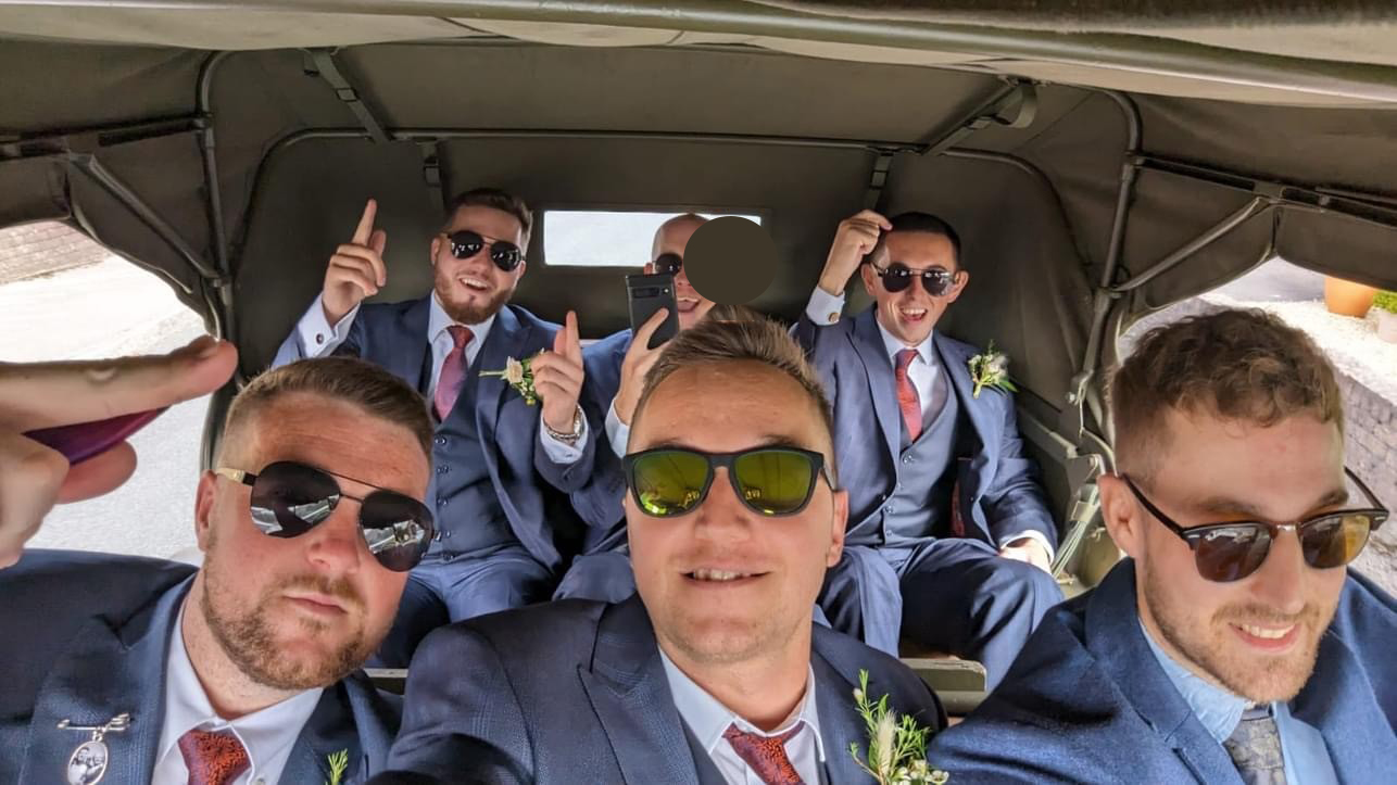 Groomsmen Selfie photo inside a Military Dodge Vehicle with soft top canvas closed.