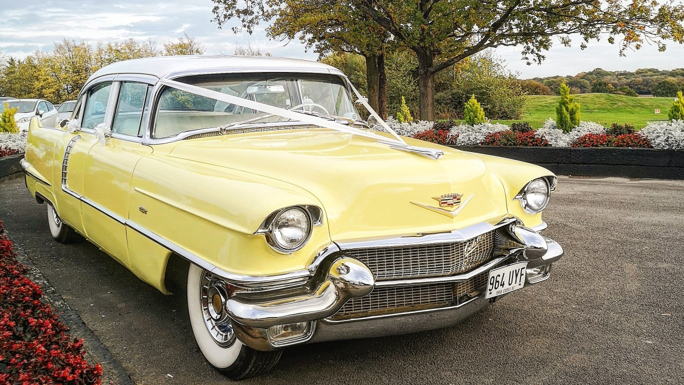 Front Right Side Cadillac Formal Sedan in yellow with white ribbons