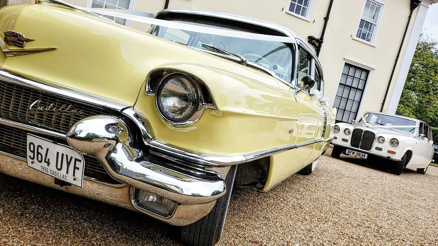 Close up front chrome bumper in front of Classic American Cadillac