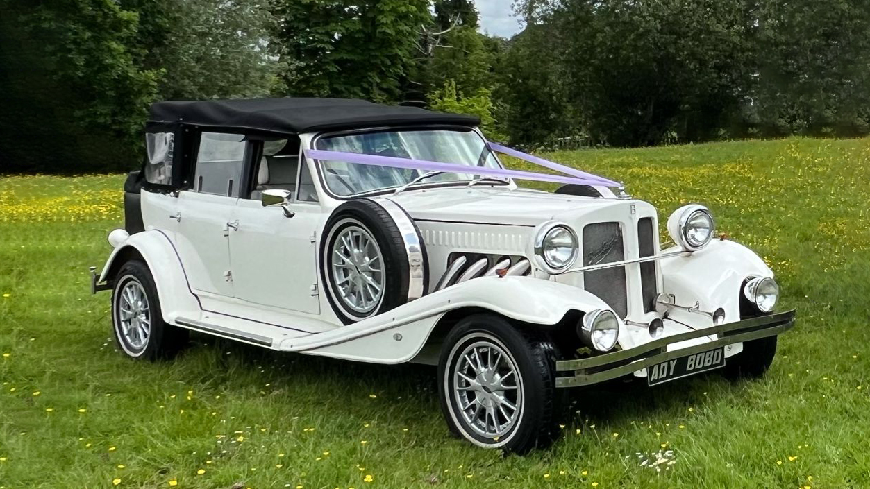 4-Door Convertible Beauford in Ivory with black soft top roof