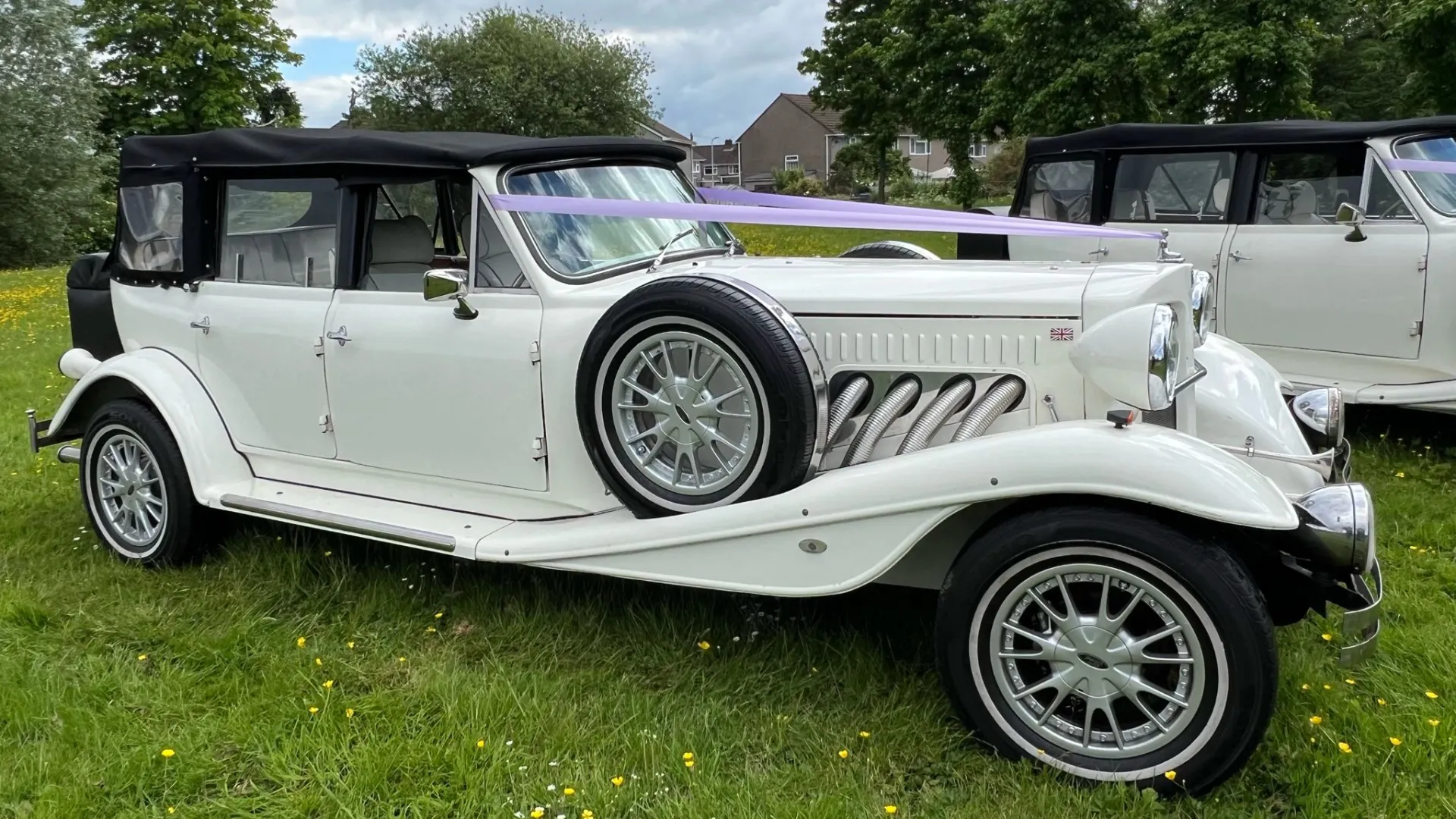 Right side view of ivory Beauford decorated with lillac ribbons and spare wheeel mounted on the side