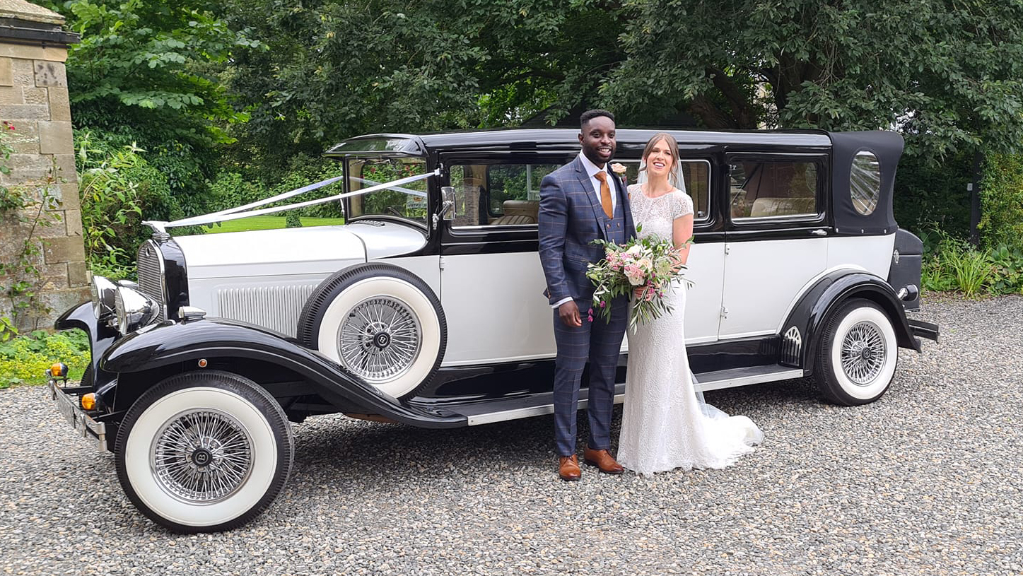 Bride and Groom standing in front of Bramwith Limousine