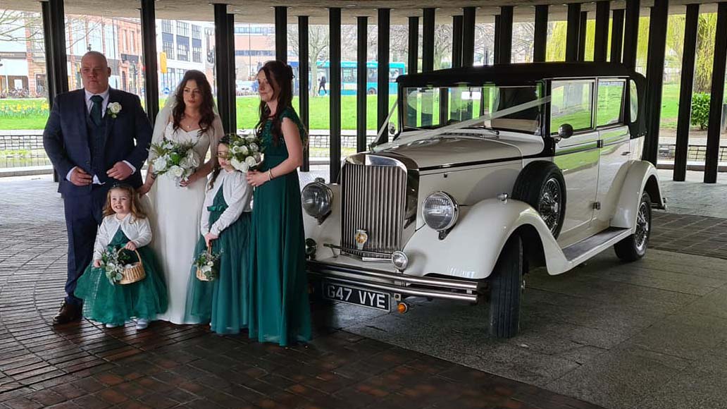 Regent Convertible in front of wedding venue with Bride and her father with Bridesmaids and Flowers girls wearing green dresses