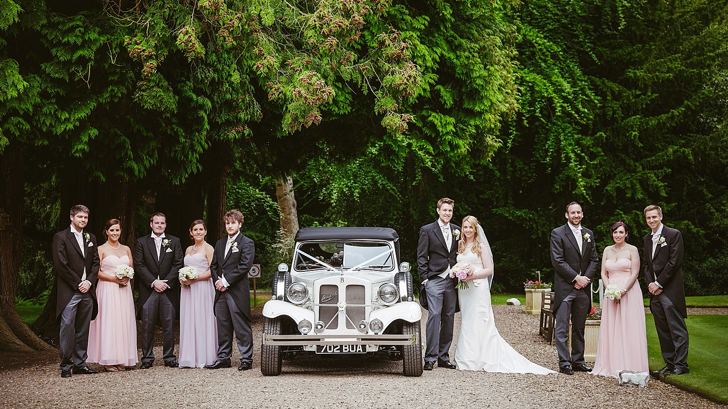 Beauford Convertible with Wedding Party pasing on both side of the vehicle