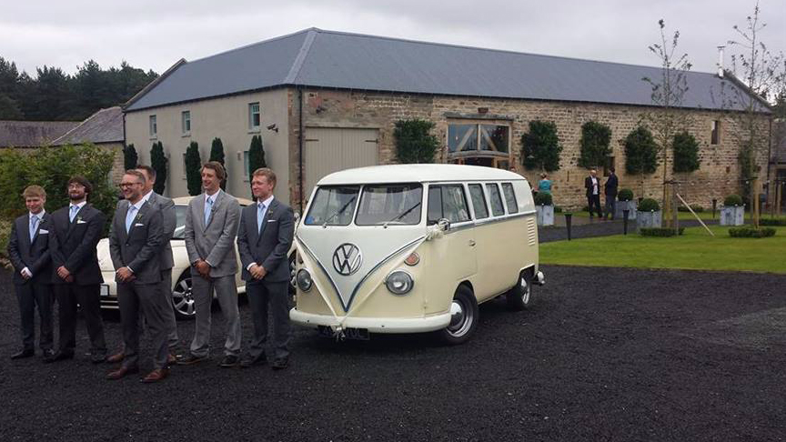 Groom and his groomsmen standing next to a Classic VW Campervan splitscreen