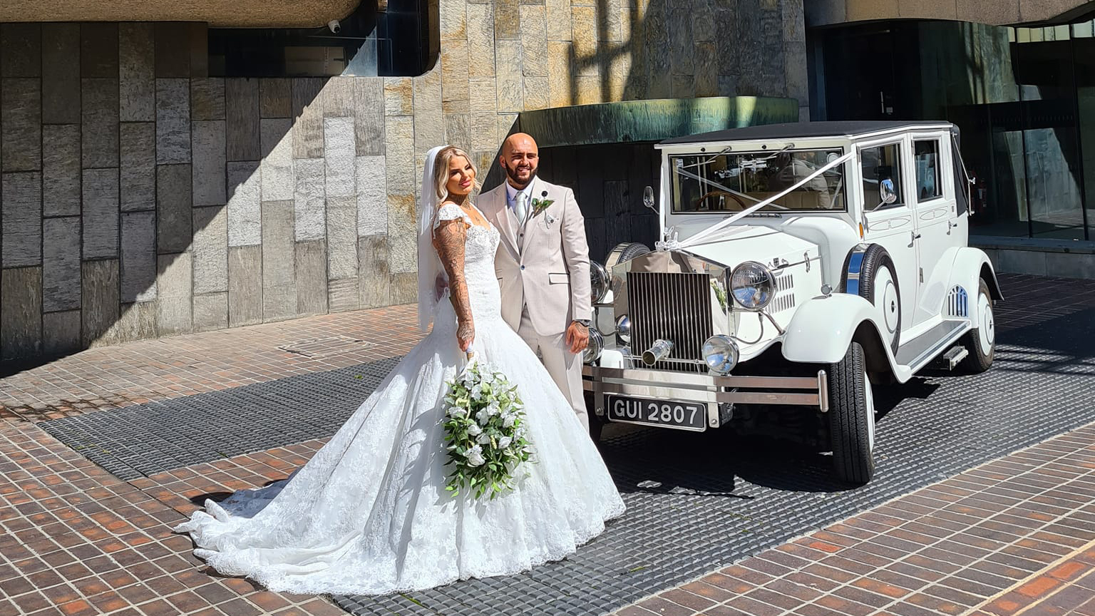 White Imperial Convertible with Bride and Groom in front of Newcastle Registry office