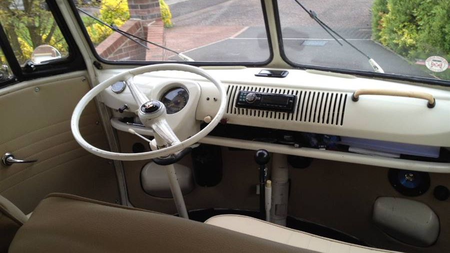 Classic VW Campervan front drive area with white dashboard.