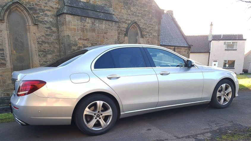 Rear side view of Silver Mercedes E-class