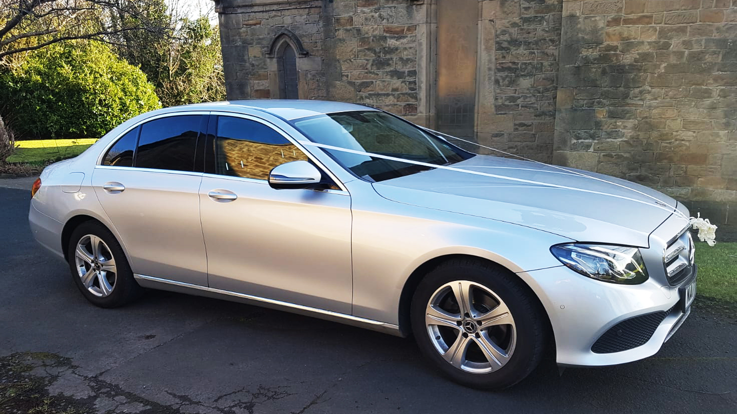 Front right side view of Silver Mercedes E-class