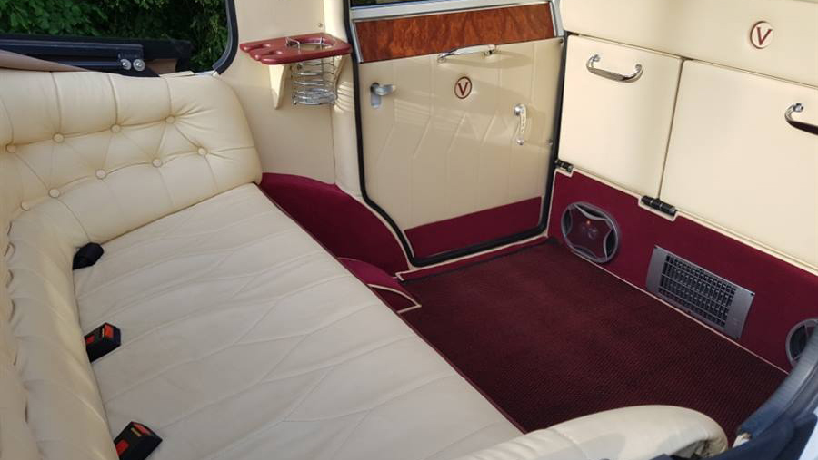 White Imperial rear interior showing cream leather bench seat with seat belts and Burgundy Carpet