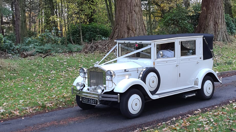 White Imperial wedding car decorated with ribbons