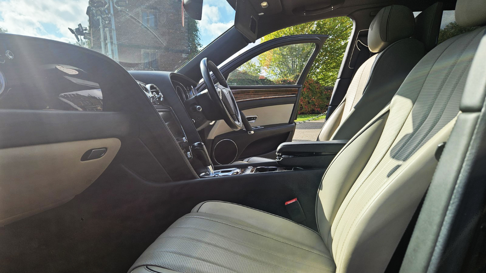 Front passenger seat with cream leather and wooden dashboard