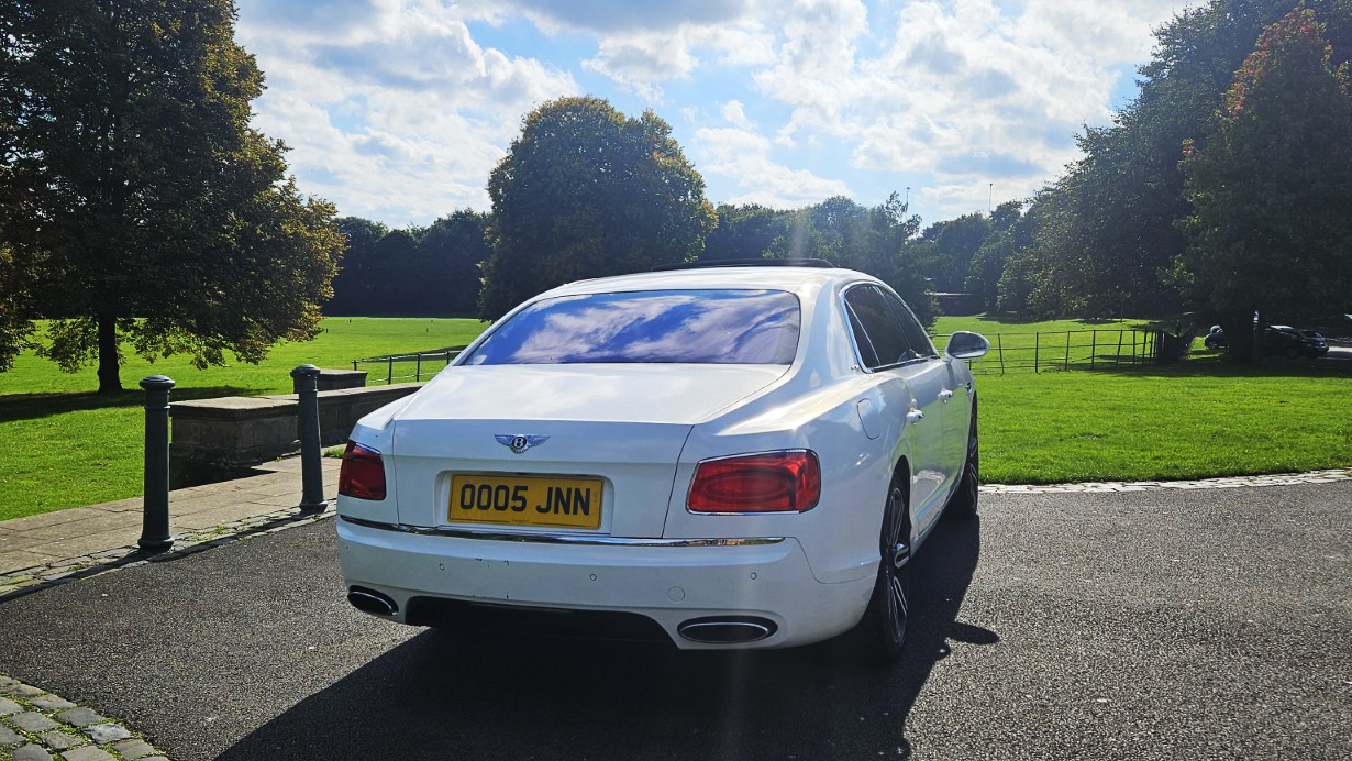 Rear view of White Bentley Flying Spur with Mulliner specs.