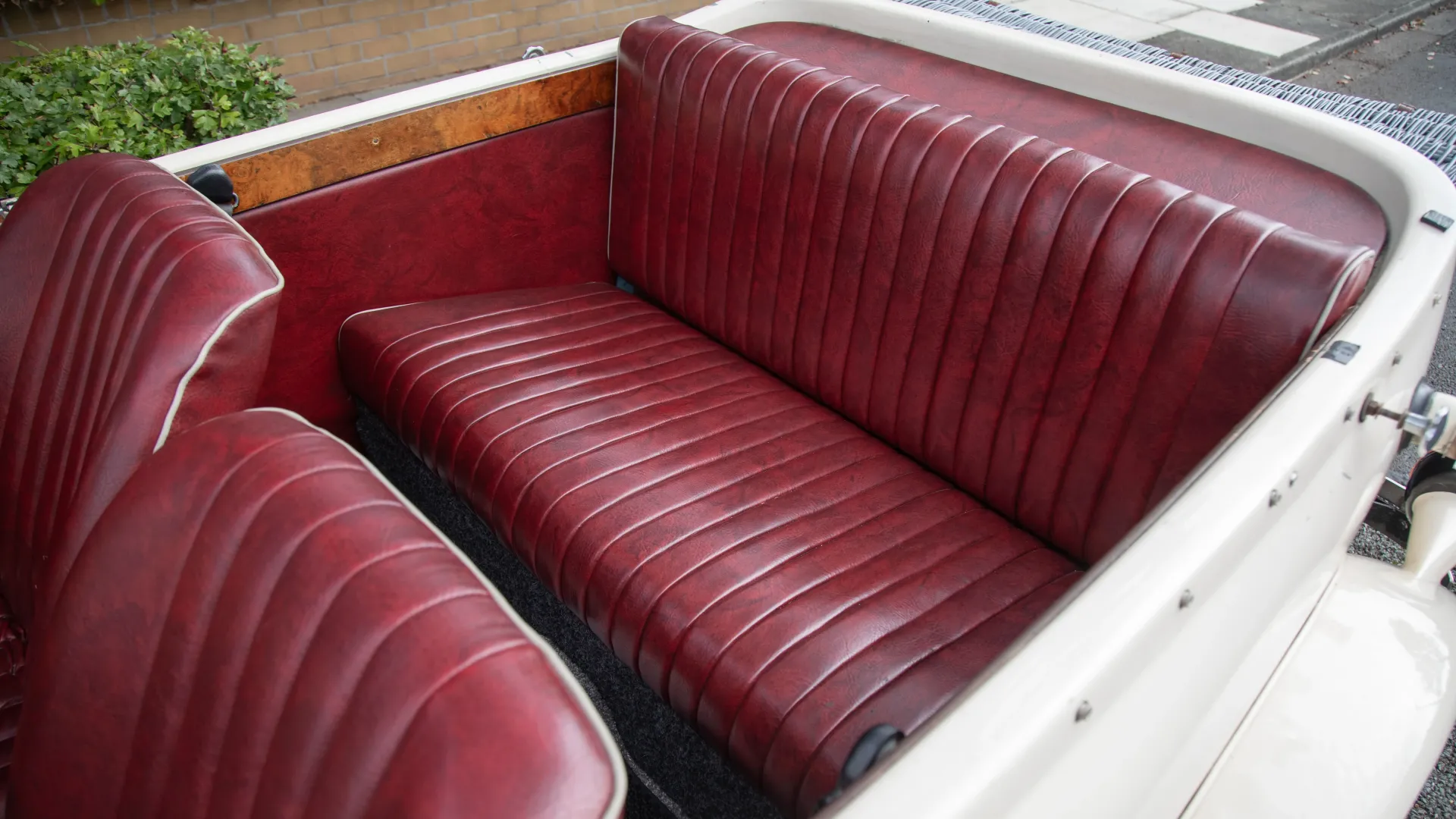 Aerial view of rear burgundy bench seat inside Beauford