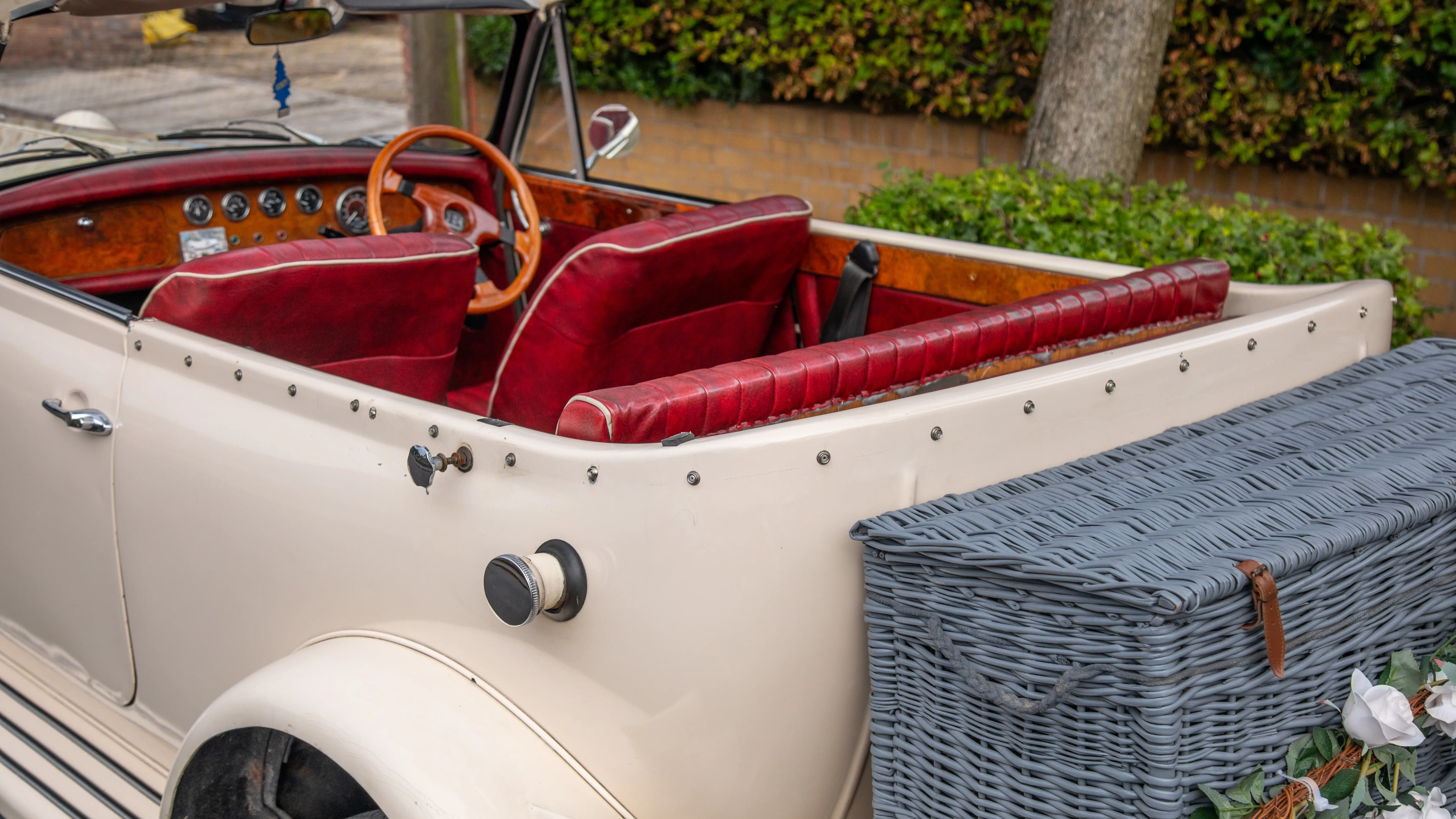 Rear view of Beauford with roof down showing the grey picnic trunk and Burgundy leather seat