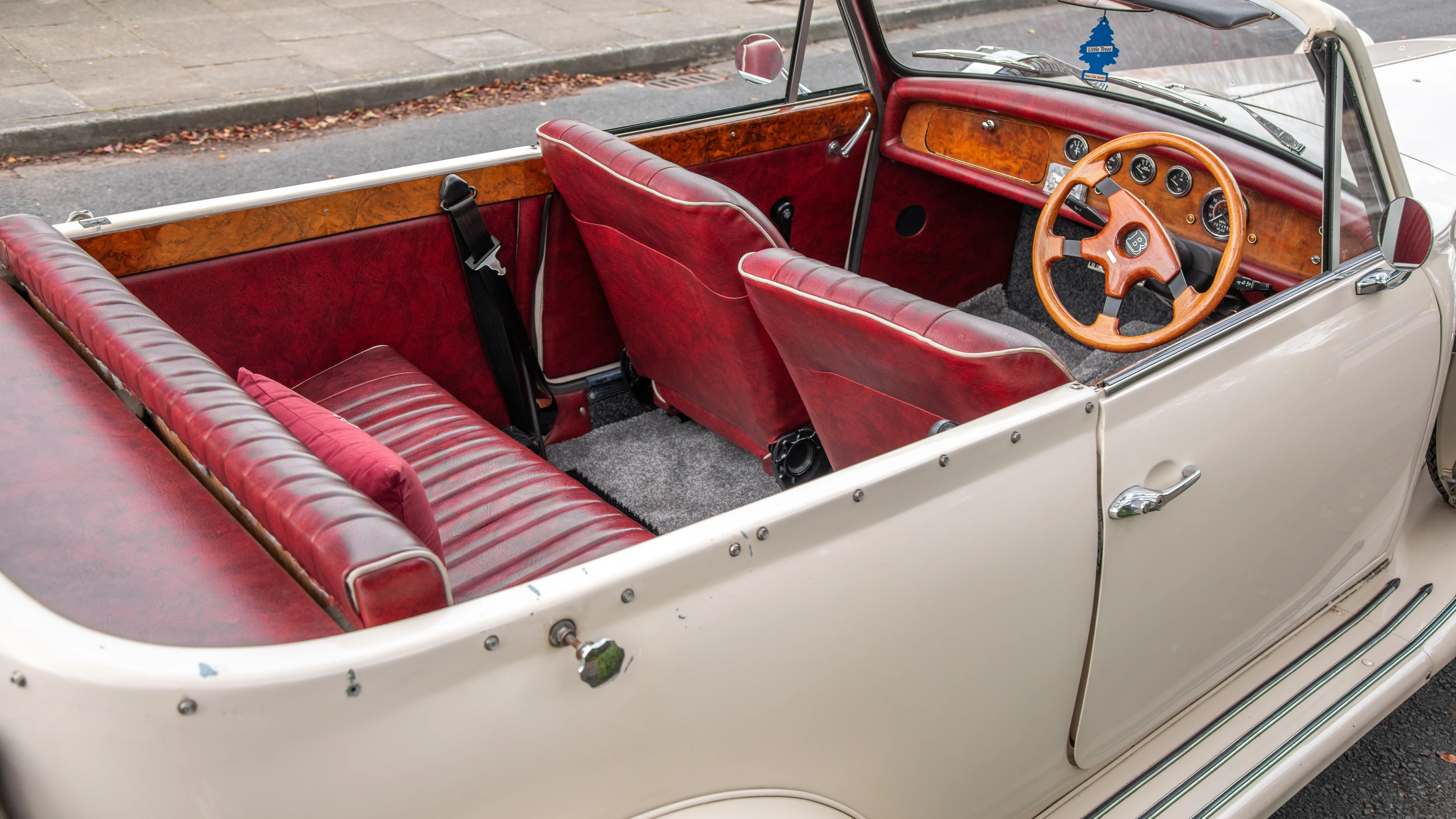 Interior space inside BEauford showing burgundy leather seat with plenty of legroom