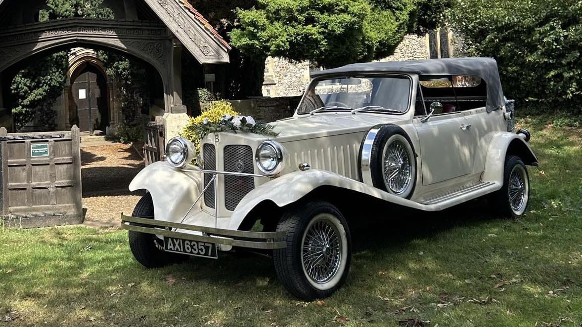 Left front view of Ivory Beauford parked in front of a church with posy of flower fitted on top of the front radiator grill