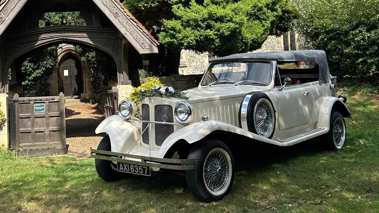 Ivory Beauford with Grey soft top hood closed parked in front of a church