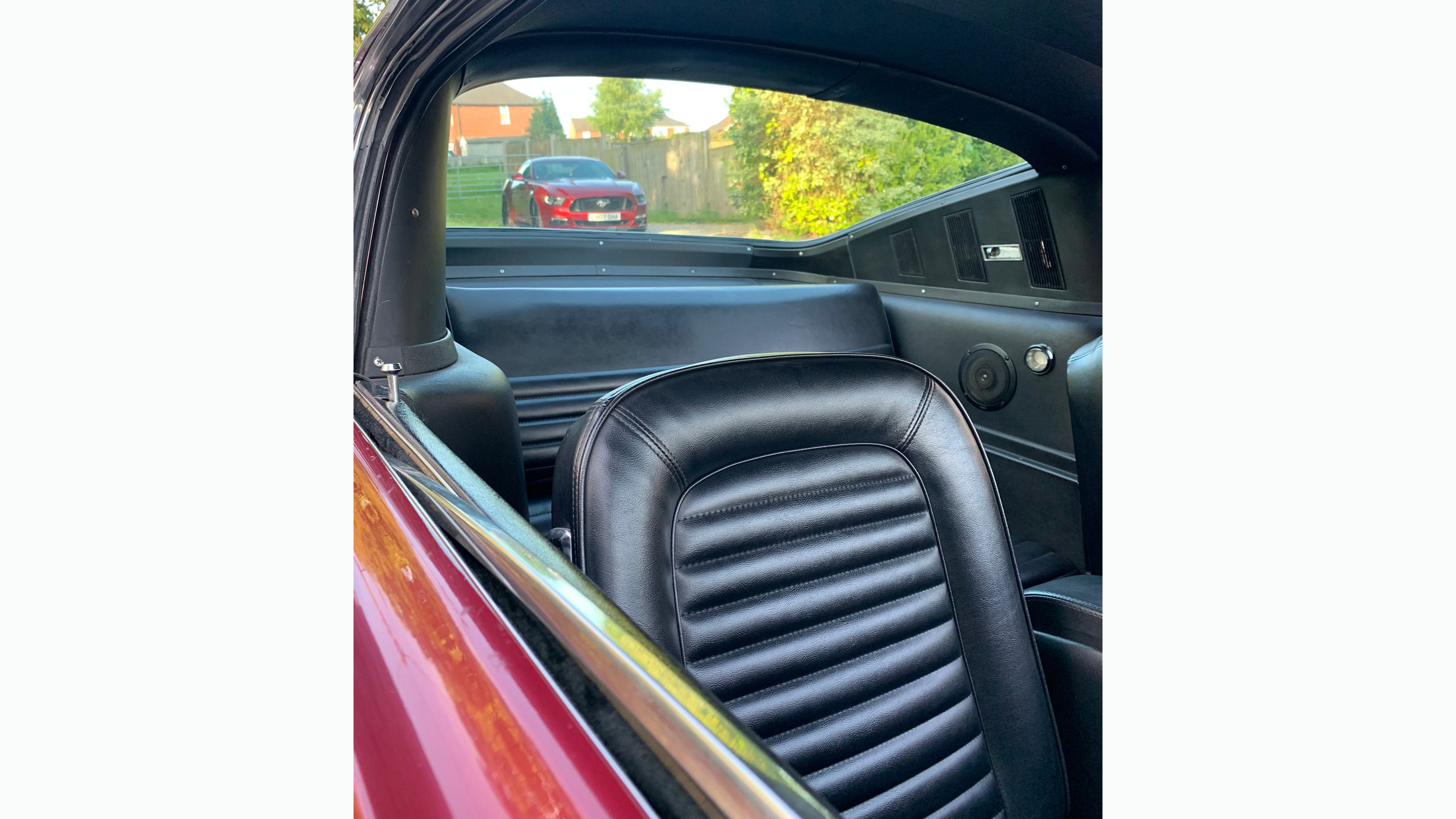 interior seating of black leather seats inside classic Fastback Mustang