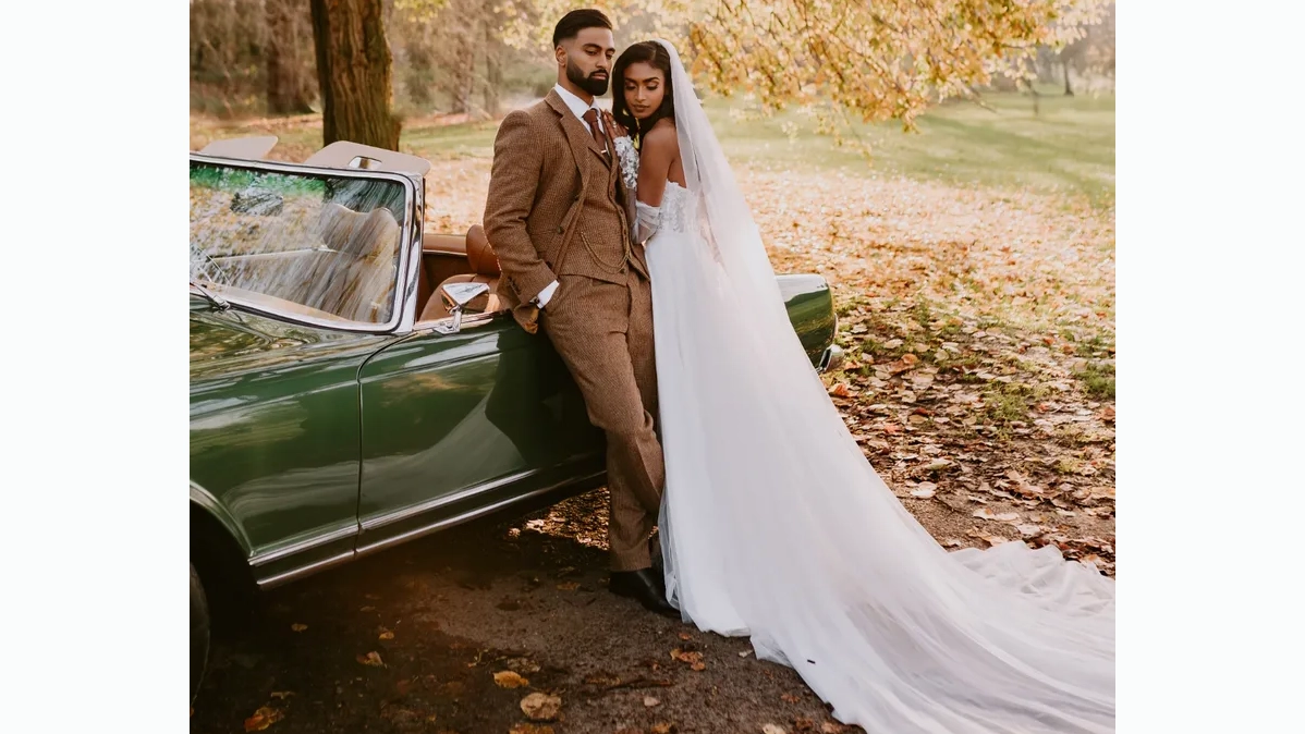 Groom leaning on a Classic Mercedes with Bride wearing a white dress holding him.