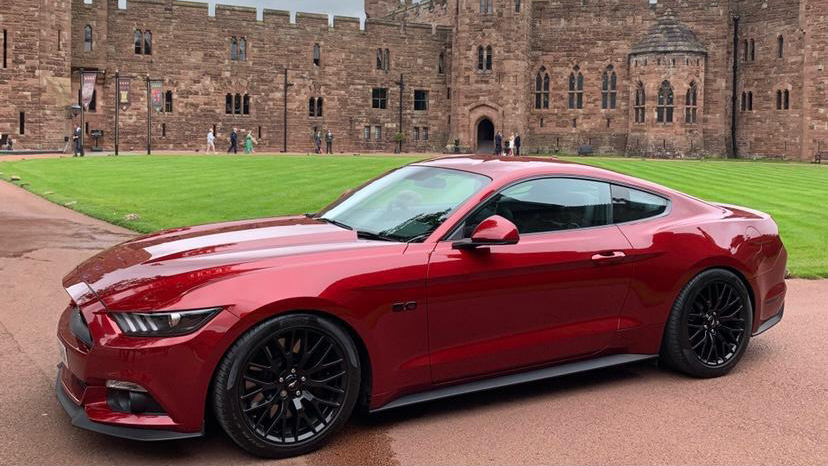 Cherry Red Mustang with black alloy wheels, 2 door fastback version