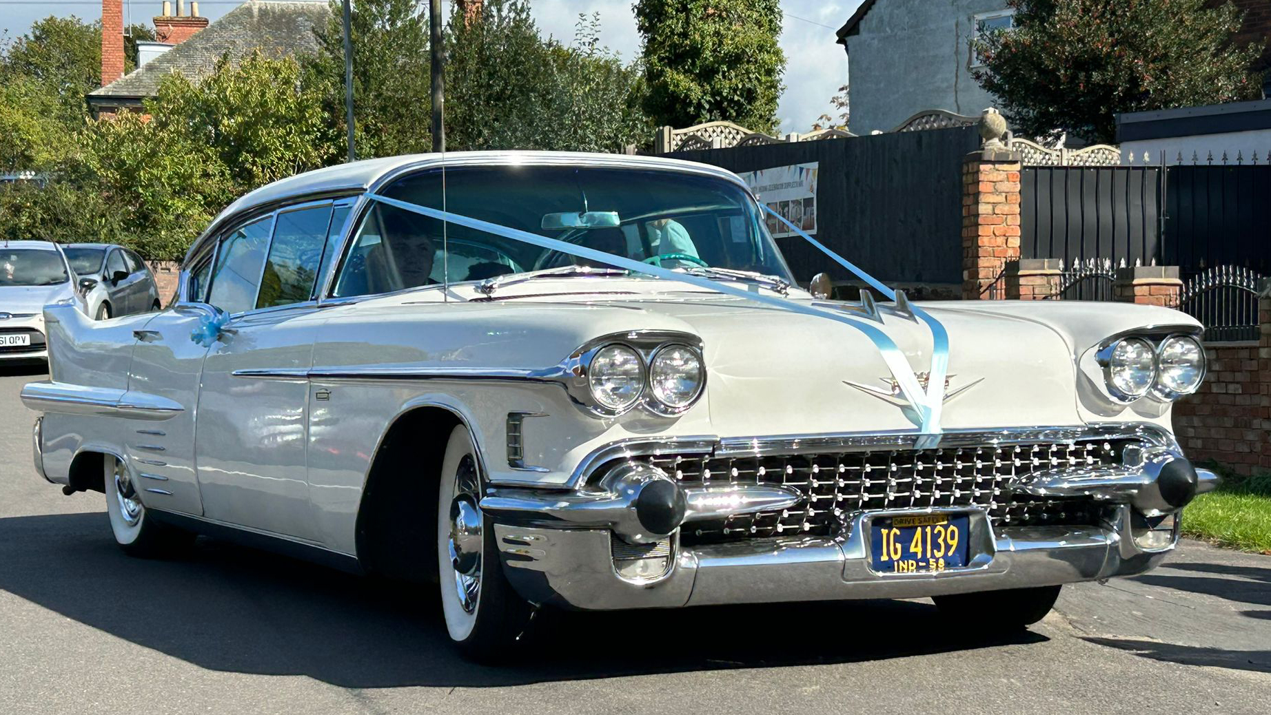 Front view of a Classic Cadillac in White with Large Chrome Bumper