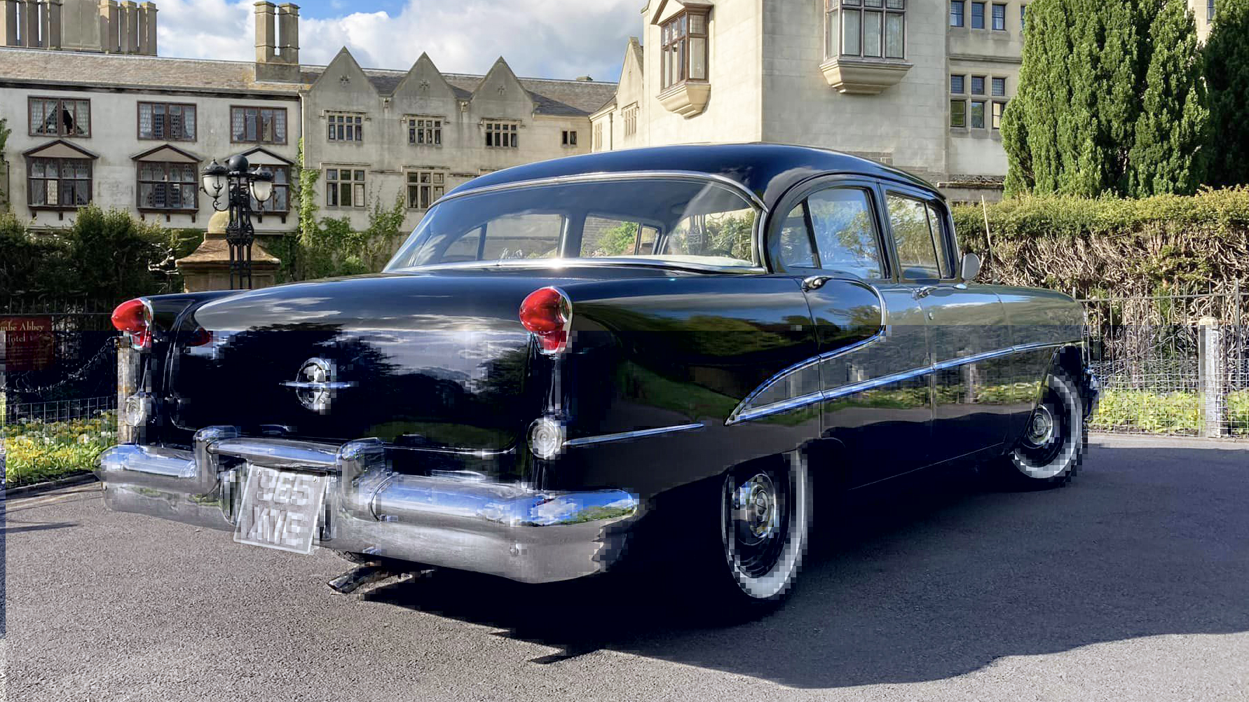 Rear view Oldsmobile with black boot