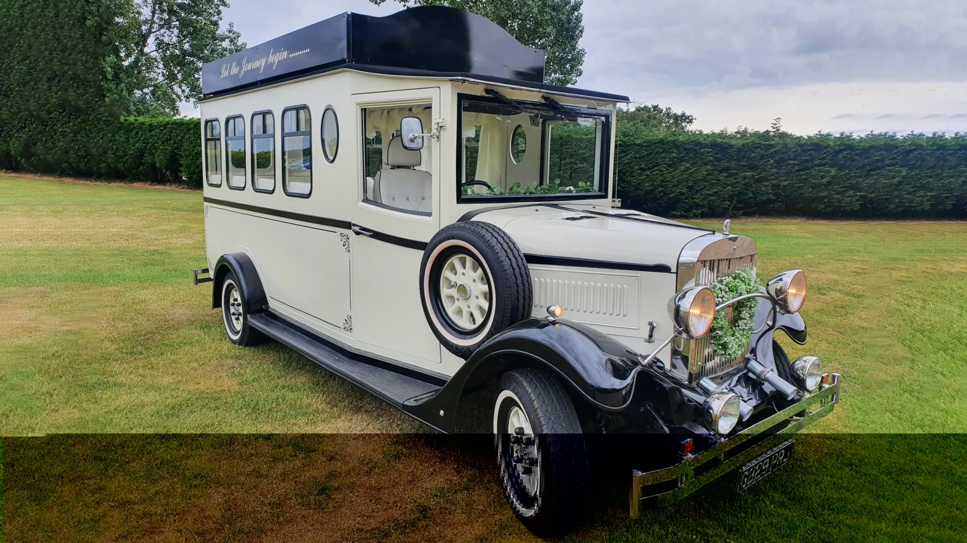 Black & Ivory Asquith Vintage Style Bus with spare wheel mounted on the side, large passengers windows at the rear