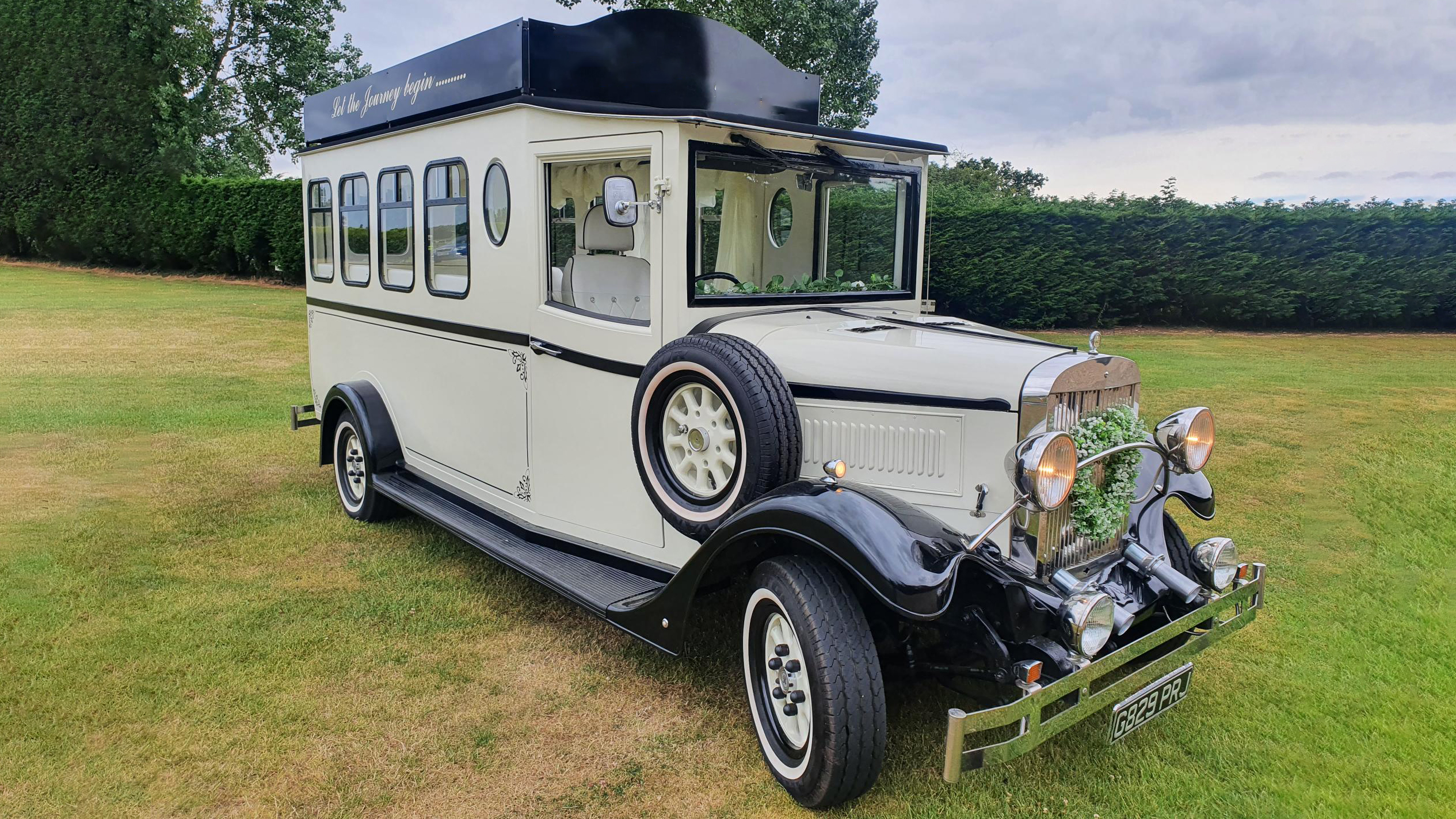 Black & Ivory Asquith Vintage Style Bus with spare wheel mounted on the side, large passengers windows at the rear