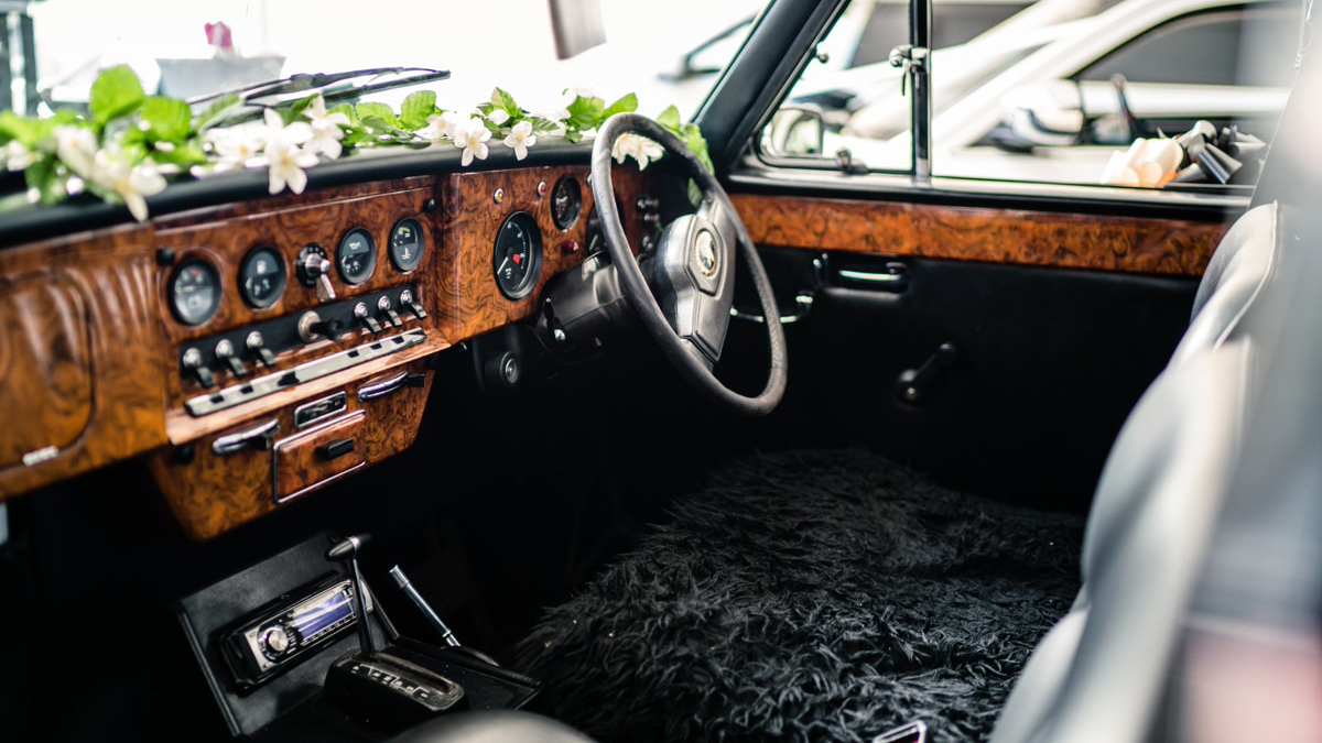 Front driver space with wooden dashboard and black seats