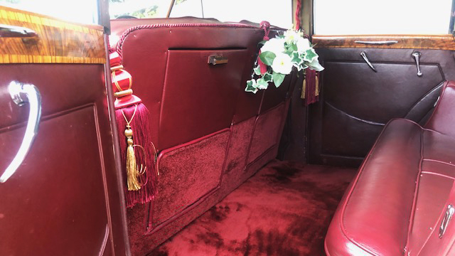 Rear interior inside a Classic Rolls-royce. Interior is Red Leather seats and Deep Red Carpet