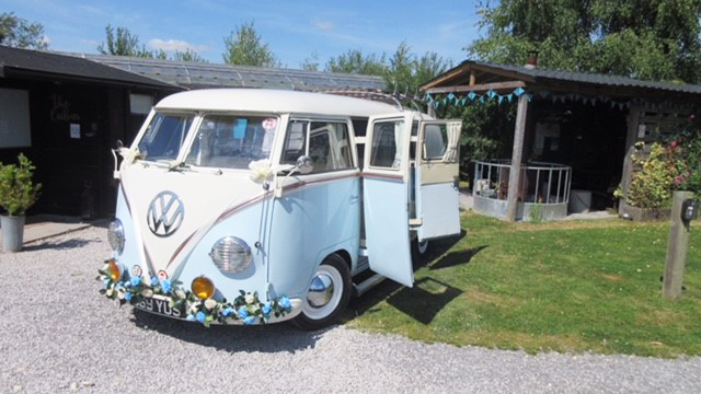 Front left view of classic VW Campervan in two tone blue and white with rear double doors open