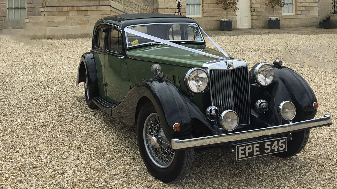 Black & Green Vintage MG SA decorated with white ribbons