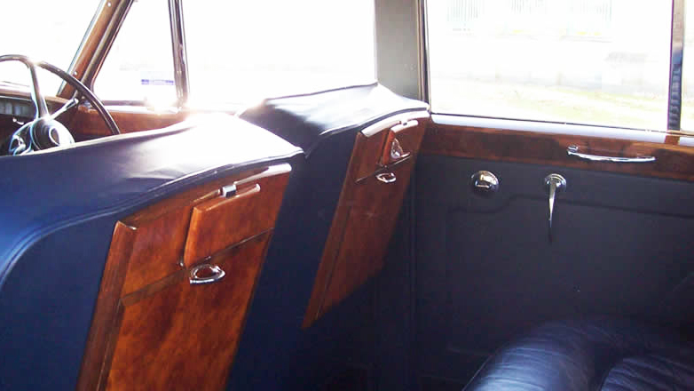 Blue leather interior with walnut wood picnic table.