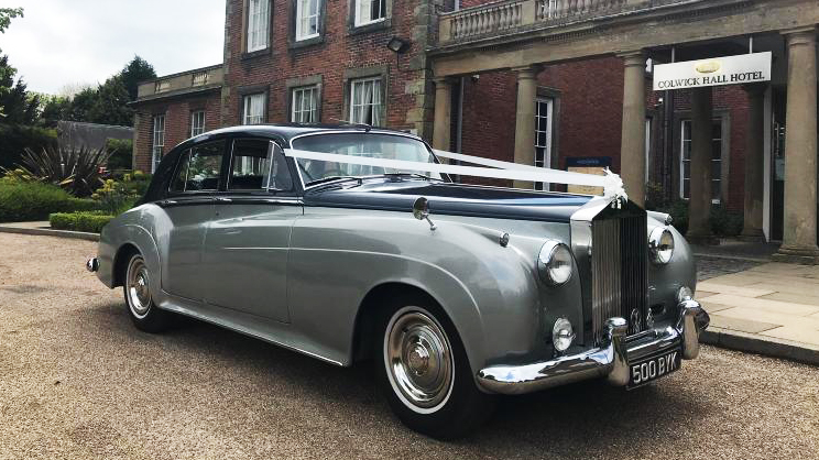 Classic Black & Silver Rolls-Royce silver Cloud decorated with white ribbons