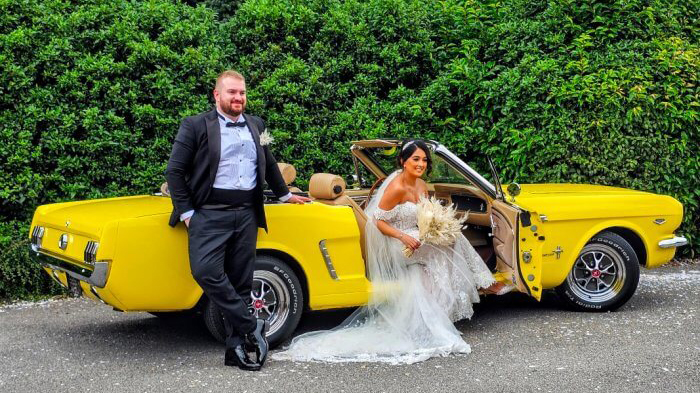 Bride and Groom with Classic Yellow Ford Mustang