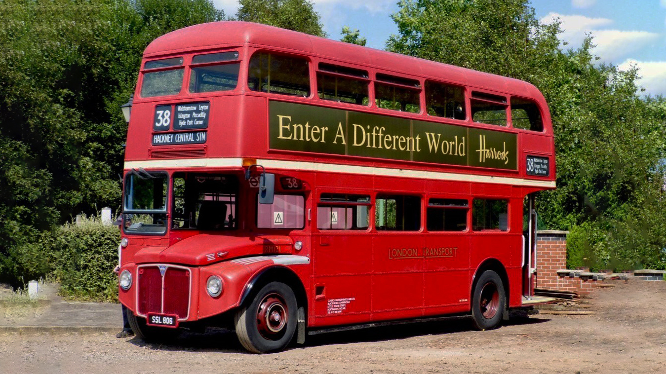 Vintage Red Routemaster bus with vintage adverts on its side