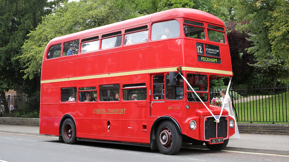 Classic Double Decker Red Routemaster Bus with wedding ribbons across the front