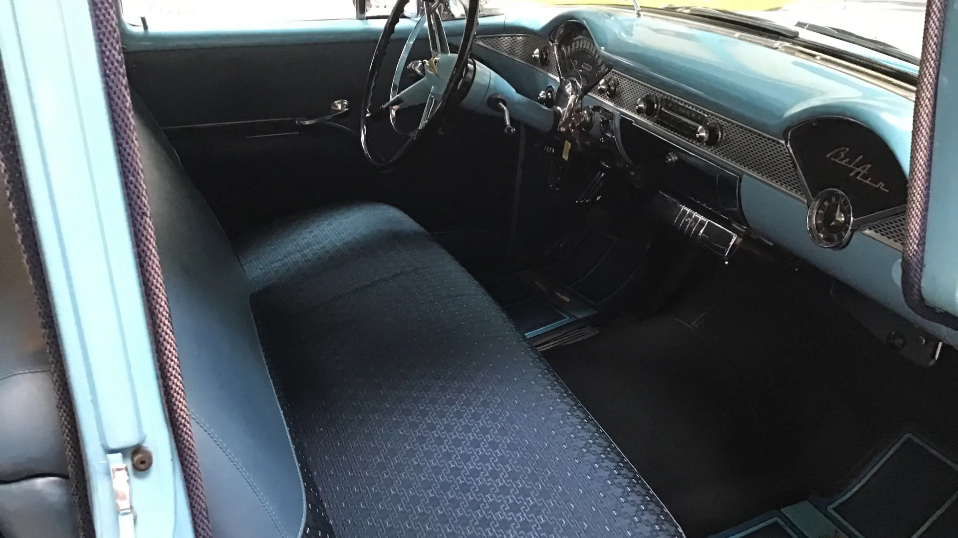 Front seat Bench inside classic Chevrolet Bel Air with light blue dashboard