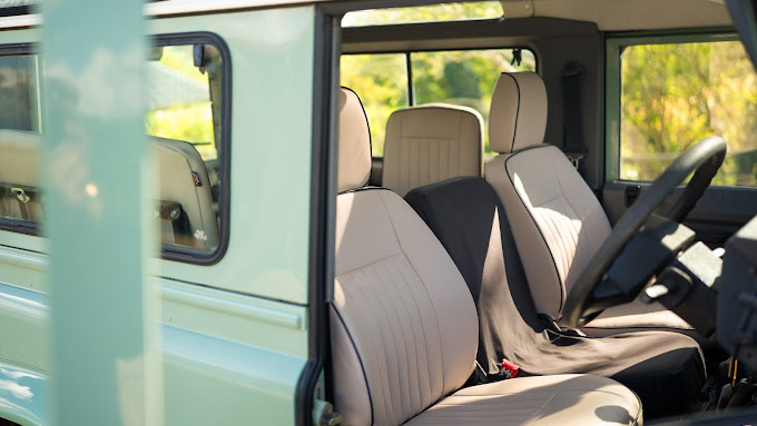 Front seats in cream leather inside a land rover defender