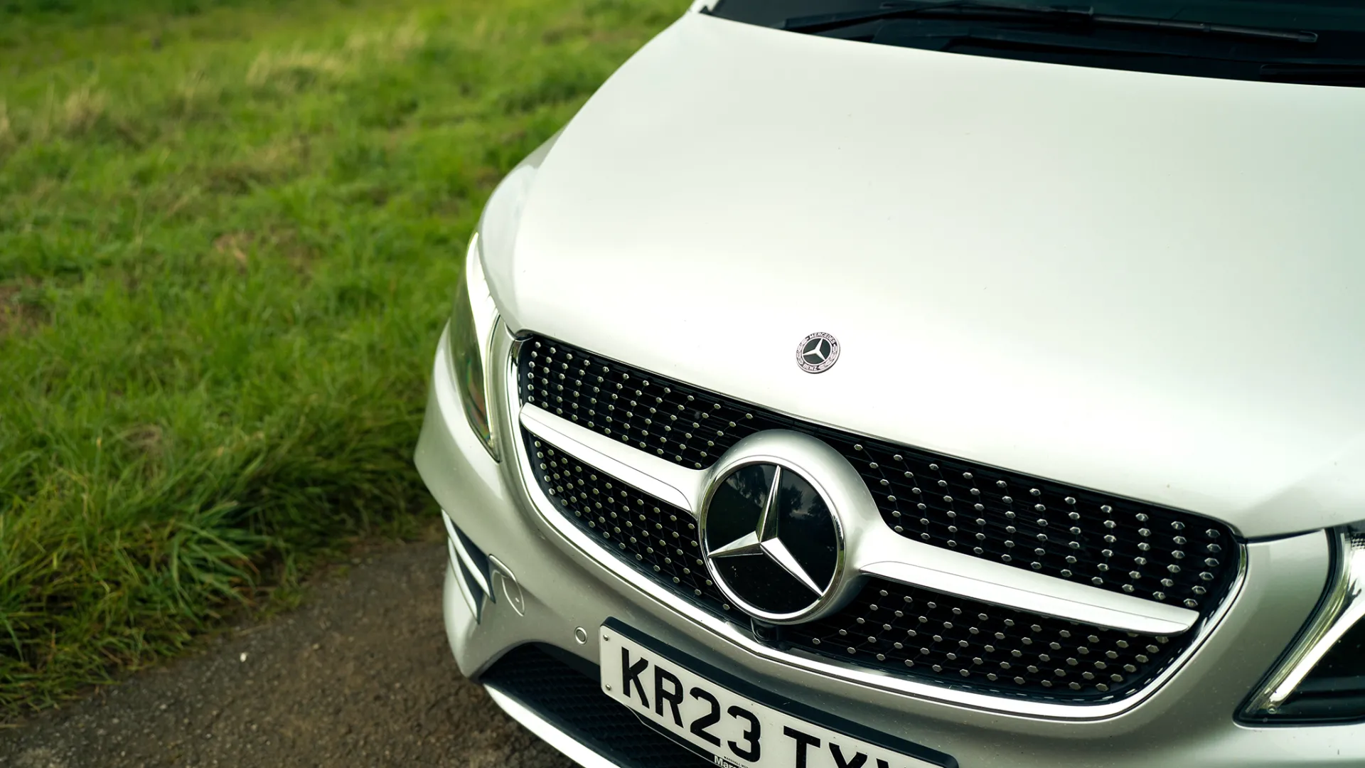 Front grill and Logo of a modern Mercedes V-Class in Silver