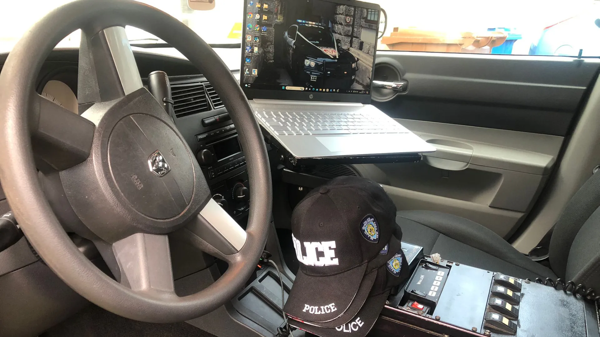 Front Driver seat and dashboard inside Dodge Charger Police Car.