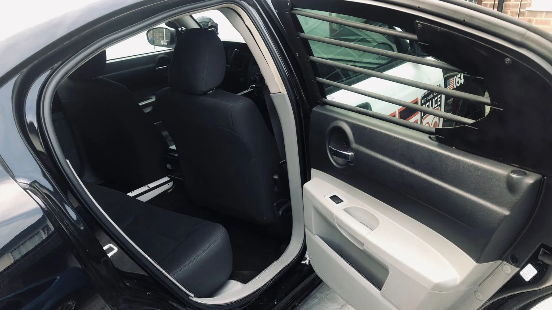 Rear interior seats inside Dodge Charge Police Car with rear door open