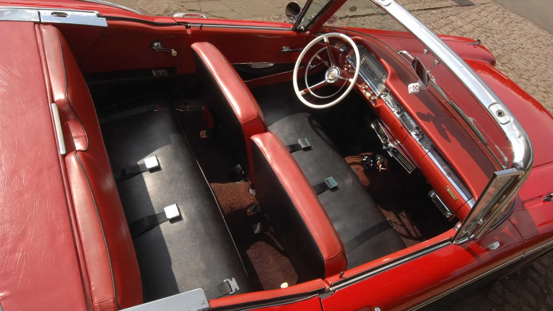 Aerial view of Ford Fairlane interior of black and red leather seats