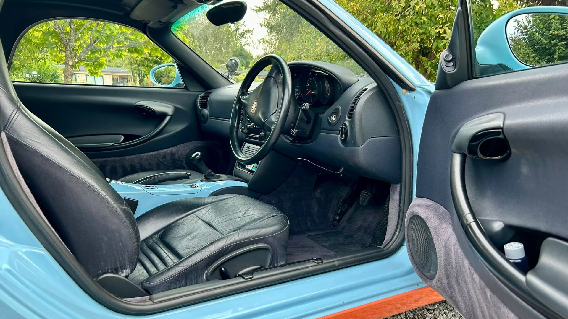 Black leater interior in porsche Boxster with driver's door open