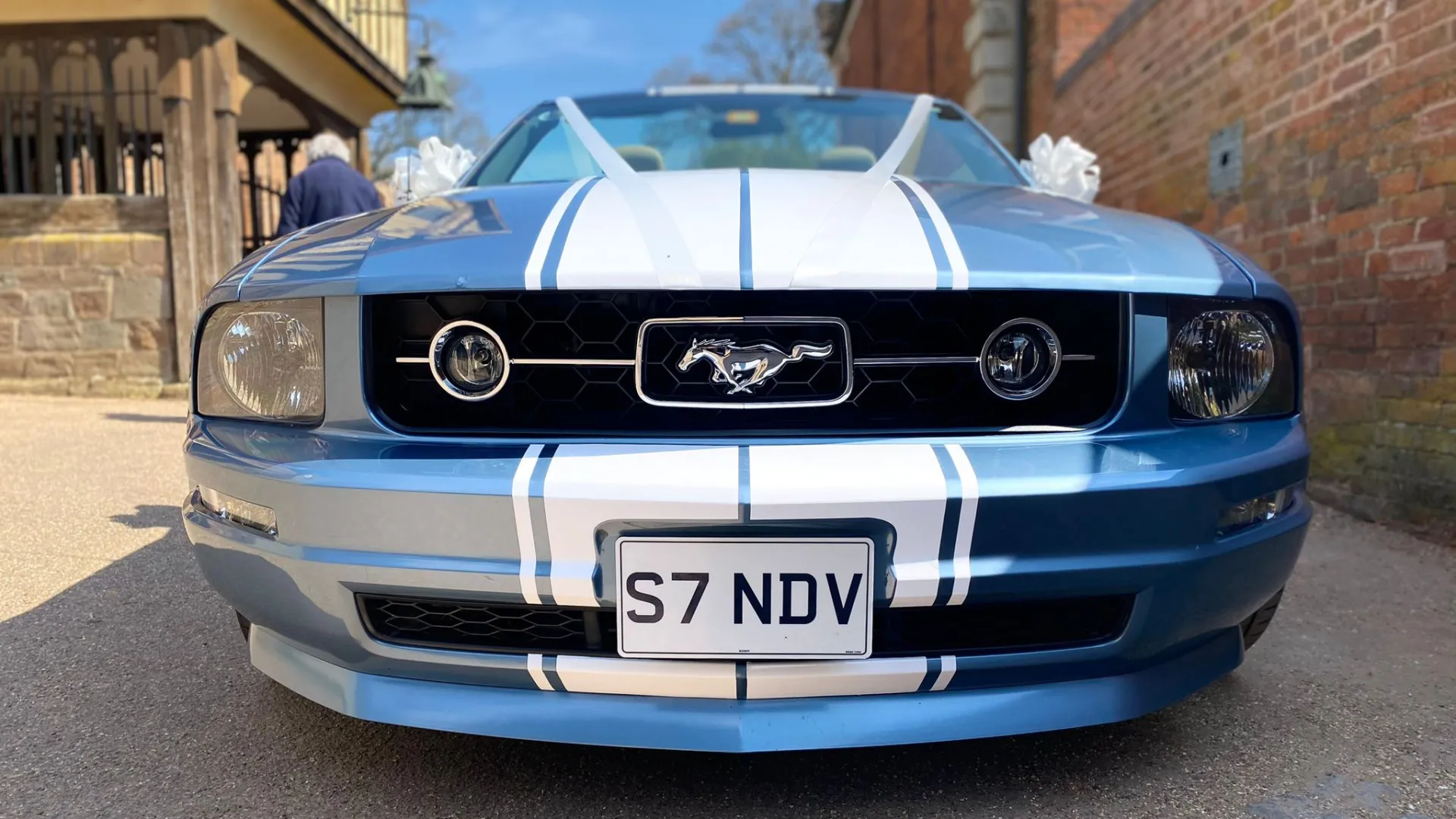 Front black grill with Mustang Pony logo on chrome in the middle of the grill