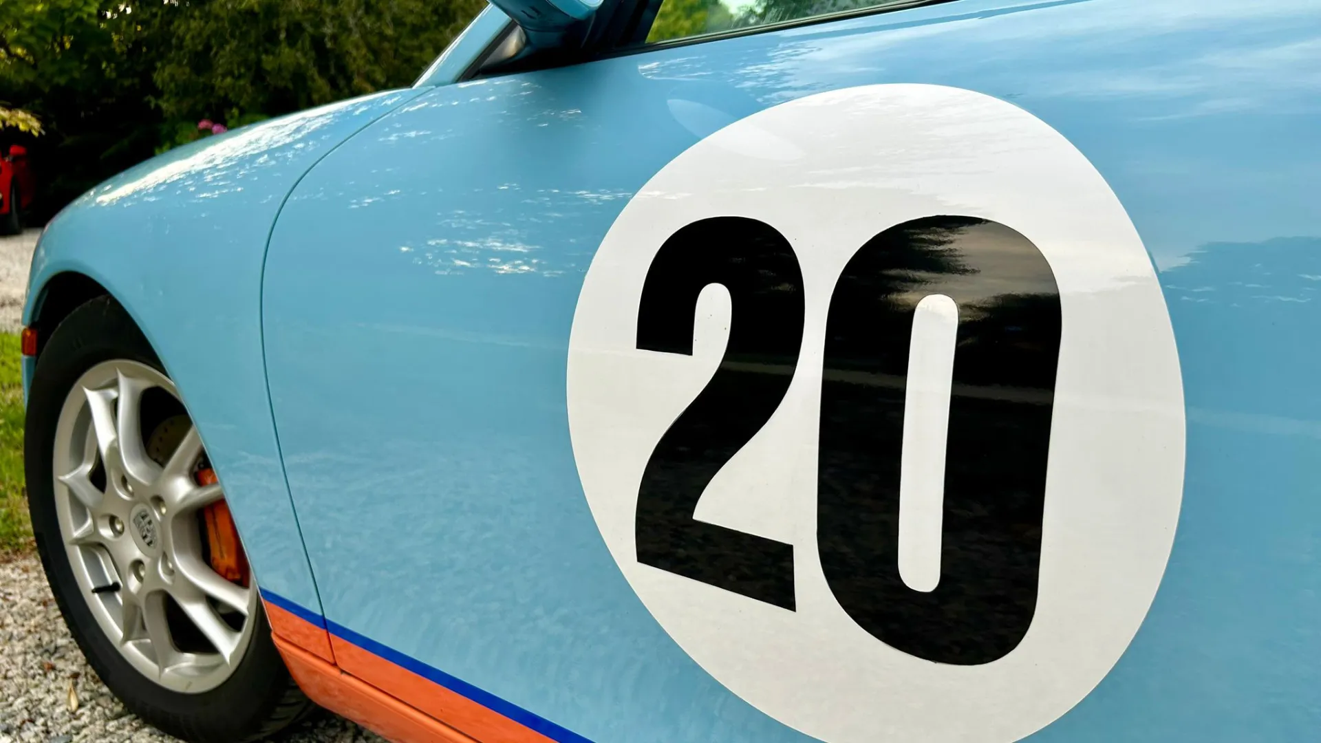 Number 20 white Logo with Black writting o the side of a Porsche Boxster door